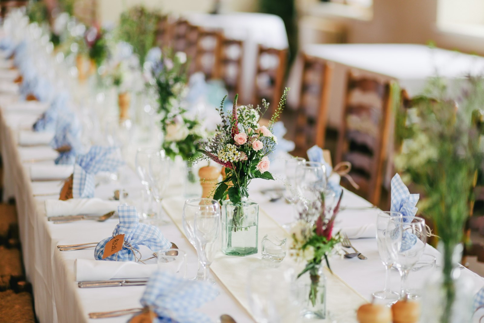 A long table set for a private celebration at Optionventurebeam, with flowers and glassware