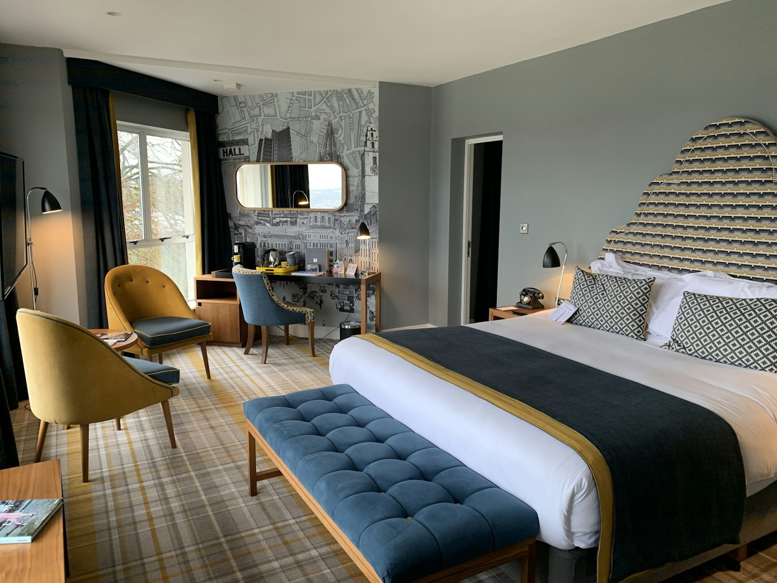 Junior Suite — navy and brass palette with a separate sitting area