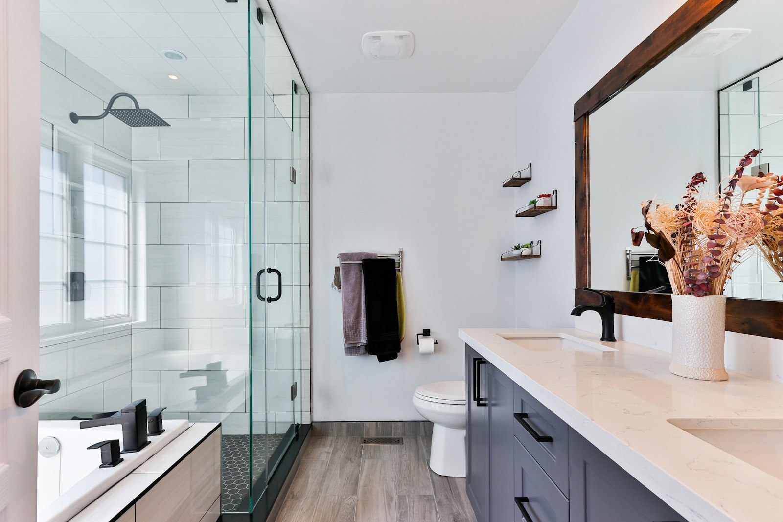 Detail of a bathroom at Optionventurebeam — stone basin, brass fittings and folded cotton towels