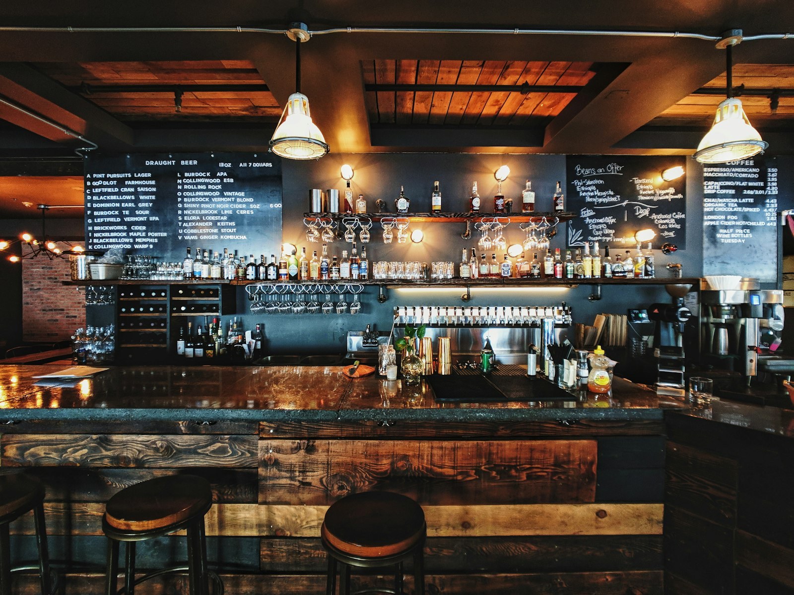 Timber bar interior of The Salon at Optionventurebeam with stools and chalkboard menus
